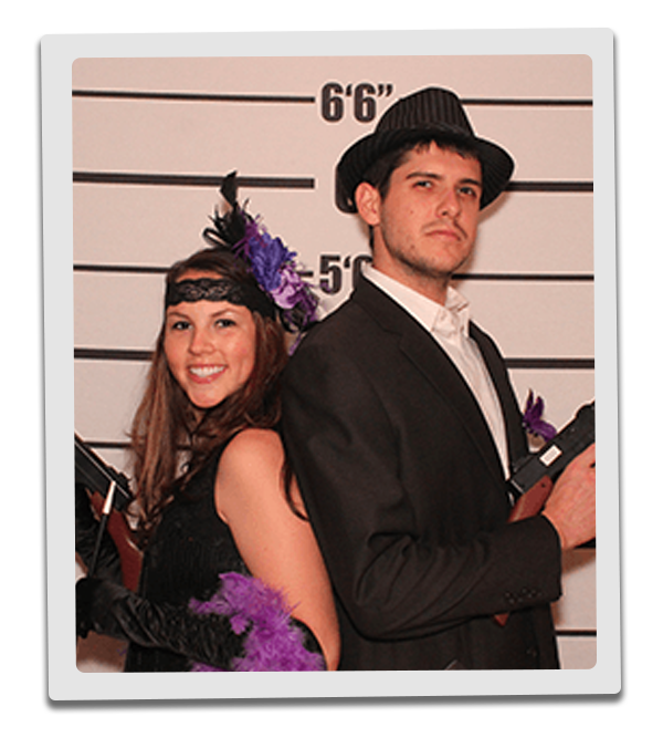 Boston Murder Mystery party guests pose for mugshots