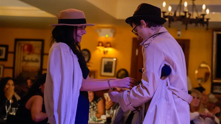 A Murder Mystery Company detective questioning a guest at a Boston show