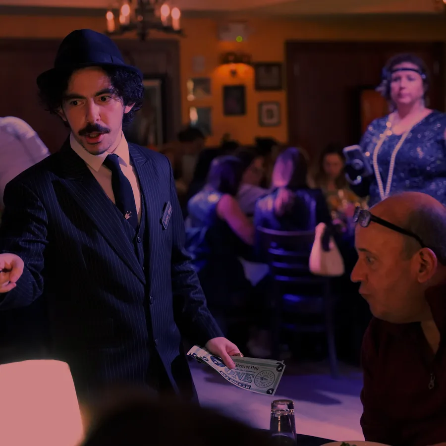 A Murder Mystery Company actor working the room at a Boston show
