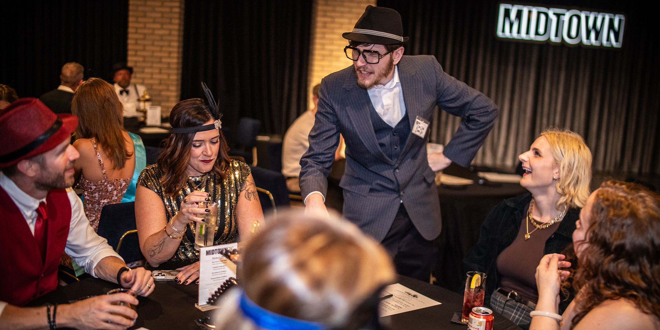 Guests at a Murder Mystery Company public dinner show in Boston